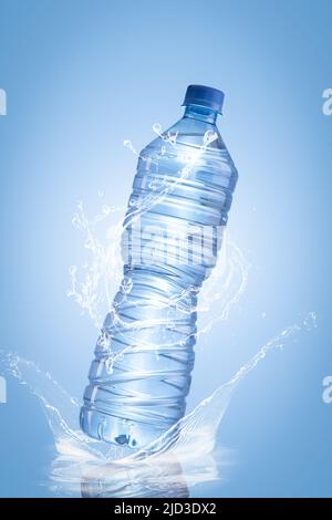 Water splash of bottle isolated on blue background. Vertical format. Stock Photo