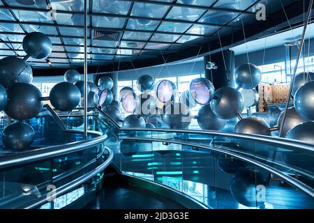 Installation of stylish connected silver balls decoration modern interior in science museum. Stock Photo