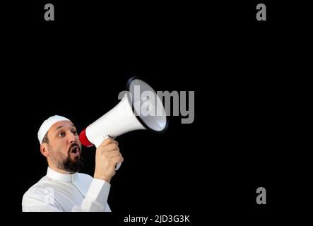 Handsome man with beard shouting through megaphone for Hajj in Mekkah Stock Photo