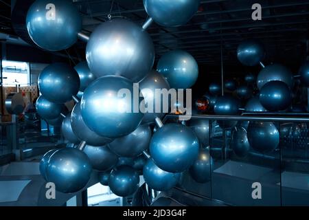 Installation of stylish connected silver balls decoration modern interior in science museum. Stock Photo