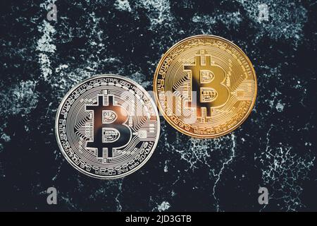 Crypto currency golden coin on black background. Two bitcoins, top view. Cryptocurrency trading technology concept Stock Photo