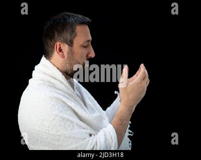 Muslim man standing and praying in the front of Kaaba in Mecca, KSA Stock Photo