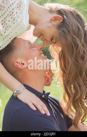 young happy attractive couple looks into each other eyes, spending time outdoors, woman and man are happy Stock Photo
