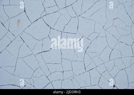 Background is sheet of metal painted with old peeling white paint Stock Photo