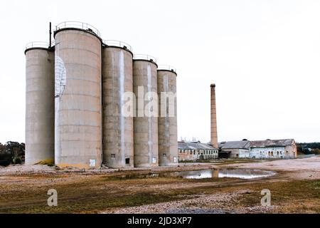 Photograph of the large cement storage silos at the now closed historic Portland Cement Works in Portland in The Central Tablelands of New South Wales Stock Photo