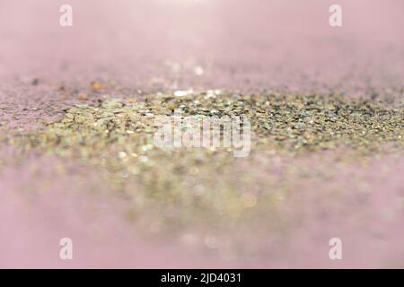 Gold sequins on pastel pink background. Festive concept.Selective focus. Stock Photo