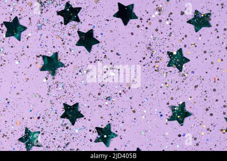 Seamless pattern with blue stars sequins on a purple background. Horizontal photo. Wallpaper, texture, background for your design and copy space. Stock Photo