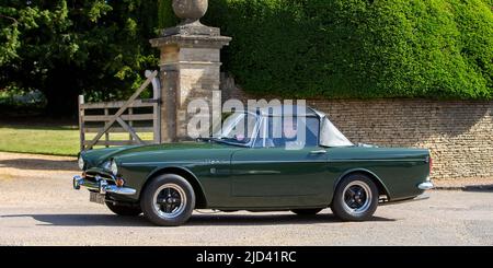 1965 SUNBEAM Tiger 4200 cc in british racing green. The Sunbeam Tiger is a high-performance V8 version of the Rootes Group's Sunbeam Alpine roadster Stock Photo