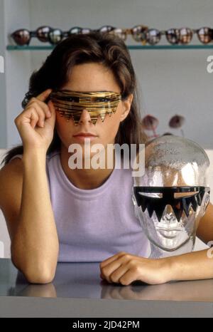 A woman poses in a pair of hip glasses at L.A. Eyeworks on Melrose Ave. in Los Angeles, CA, circa 1980s. Stock Photo