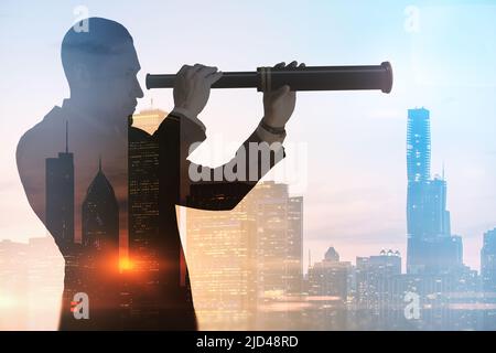 Business development and personal growth concept with businessman silhouette looking through a spyglass at city skyline background on sunset, double e Stock Photo