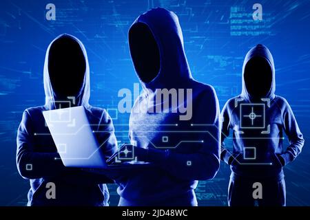 Cyber protection and internet system hacking concept with blue shadows faceless hackers in hoody using laptop and abstract virtual technological symbo Stock Photo