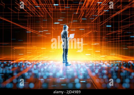 Anonymous internet user and cyber space concept with back view on person in hoodie with laptop on abstract digital technology backdrop Stock Photo