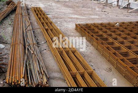 Stacked rusty steel wire mesh for slab concrete work at the construction site Stock Photo