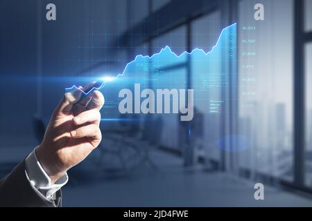 Analytics and investing concept with businessman hand touching virtual screen with stock market growing up graph Stock Photo