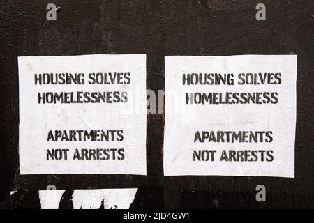 Housing solves homelessness. Apartments not arrests. Hand-cut posters in Chinatown district of Manhattan in New York City, United States of America. Stock Photo