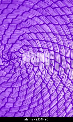 Spiral pattern of vibrant purple colored woven water hyacinth place mat Stock Photo
