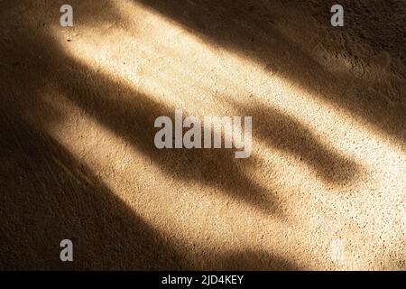 Light and shadow falling on the brown concrete floor. use for background Stock Photo