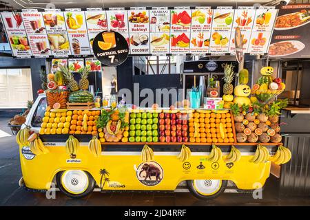 18 May 2022, Antalya, Turkiye: Juice bar and fruit shop stall at the city street in form of a retro volkswagen bus Stock Photo