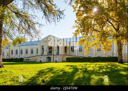 Front facade of Vääna Manor. Sunny autumn weather drew tourists and visitors to enjoy the beautiful manor. Main building now houses a school. Stock Photo