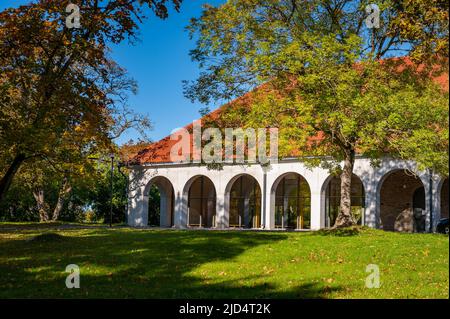 View of the outside of a renovated stable block of Vääna Manor. Old stables now houses a school. Sunny autumn weather drew tourists to enjoy the beaut Stock Photo