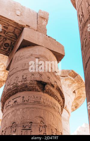 Real ancient Egyptian hieroglyphics engraved in a stone pillar at Karnak Temple in Luxor Egypt Stock Photo