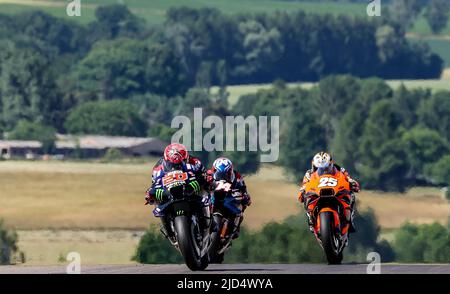 Hohenstein Ernstthal, Germany. 18th June, 2022. Motorsport/Motorcycle, German Grand Prix, 3rd free practice Moto2 at Sachsenring. Fabio Quartararo (l-r) from France of the Monster Energy Yamaha MotoGP Team crosses the track ahead of Andrea Dovizioso from Italy of the WithU Yamaha RNF MotoGP Team and Raul Fernandez from Spain of the Tech3 KTM Factory Racing Team. Credit: Jan Woitas/dpa/Alamy Live News Stock Photo