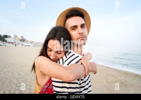 Portrait of a young caucasian couple in love. The girlfriend piggybacking the boyfriend. Stock Photo