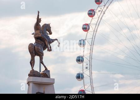 19 May 2022, Antalya, Turkey: Heart of Antalya Ferris wheel amusement park and Mustafa Kemal Ataturk equestrian statue Stock Photo