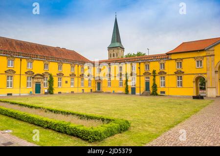 Church tower and courtyard of the castle in Osnabruck, Germany Stock Photo