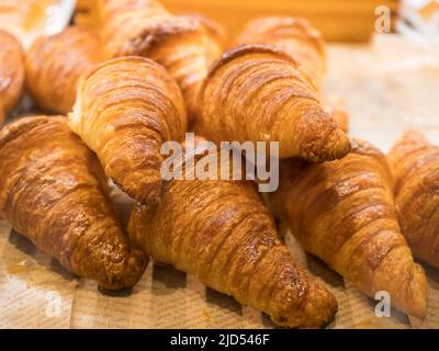 Tasty croissants on the tray sellin in the bakery shop. Stock Photo