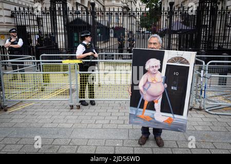 London, UK. 18th June, 2022. Artist Kaya Mar poses in front of Downing Street with his latest piece of art. Thousands of people take to the streets for a national demonstration. With inflation spiralling out of control the Trades Union Council organised the protest to raise awareness about the cost of living crisis. Credit: Andy Barton/Alamy Live News Stock Photo