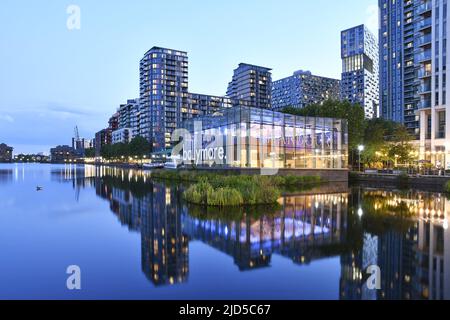 Millharbour residential properties and Design Cube marketing suite dusk reflection, located in Millwall east London UK. Stock Photo