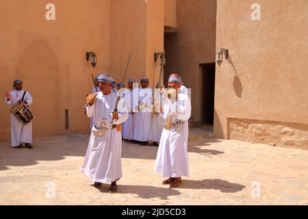 March 17 2022 - Nizwa, Oman: Omani men dancing a traditional sword dance at the Nizwa Fort Stock Photo