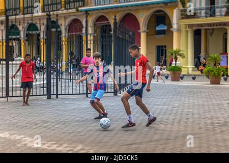 Young boys play football on Havana's famous Plaza Vieja in Havana, Cuba Stock Photo