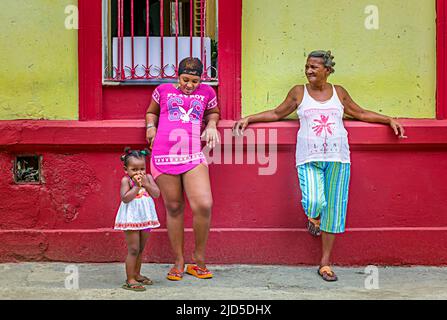 Three generations of women outside their home in Old Havana, Cuba Stock Photo