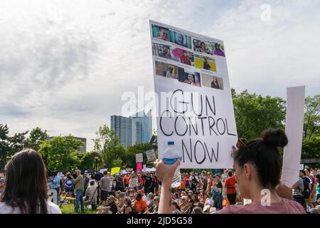 Boston, MA, US-June 11, 2022: March for Our Lives Protest Rally in Boston's Christopher Columbus Park in the North End. Protesters holding anti-gun si Stock Photo