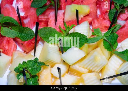 The plate is diced and decorated with melon and watermelon Stock Photo
