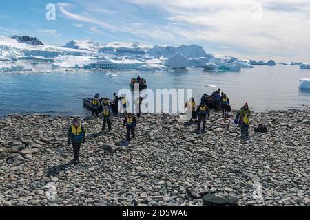 Ecotourists landing at Cuverville Island in the Errera Channel, on the western side of the Antarctic Peninsula Stock Photo