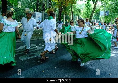 Madrid, Spain. 18th June, 2022. A group of people from the Bolivian origin dance during the carnival parade of the Flor del Patujú festival at the Paseo del Prado in Madrid. Credit: SOPA Images Limited/Alamy Live News Stock Photo