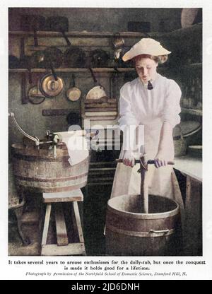 A laundry worker using a dolly stock and tub to clean clothes, prior to the invention of the washing machine. Colourised version of : 10195917       Date: 1911 Stock Photo