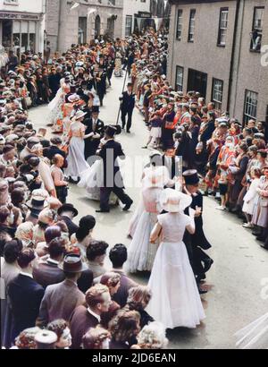 ENGLAND - Floral Dance (8 May) Furry Day, Helston, Cornwall. One of the dances that occur during the day is one for couples in evening wear who weave in and out of the houses. Colourised version of : 10088869       Date: 1950s Stock Photo