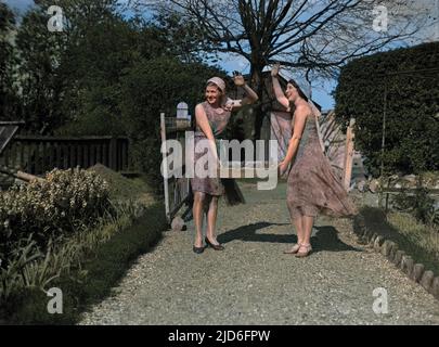 Two waving girls with a tray of fresh cucumbers. Colourised version of : 10167514       Date: 1930s Stock Photo