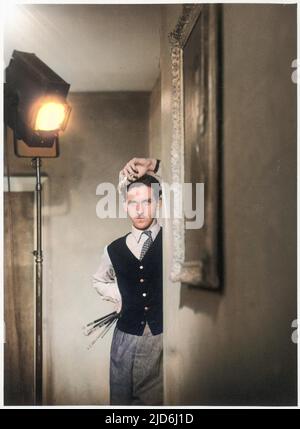 Photographic portrait of Malcolm Haylett, artist and painter pictured at his home in St. Ives, Cornwall, holding his brushes and looking rather moody! Colourised version of: 10238797       Date: c.1950 Stock Photo