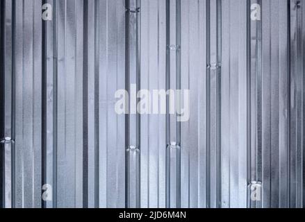Shiny, corrugated, galvanized metal wall, front view. Blue metallic hue. High resolution full frame textured abstract background. Copy space. Stock Photo