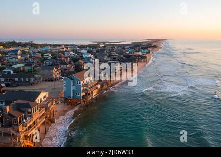 Aerial View of homes right on the shoreline in Buxton North Carolina Hatteras Island at sunrise Stock Photo