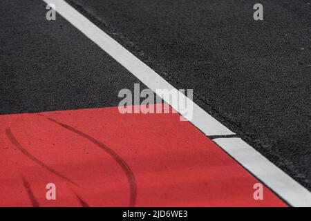 Asphalt decorated with a white line and a red field Stock Photo