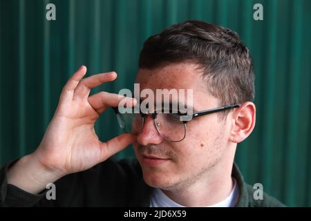 Man wearing eyeglasses. Happy smiling smart man. Portrait of handsome smiling stylish hipster lambersexual model. Male on the modern background Stock Photo