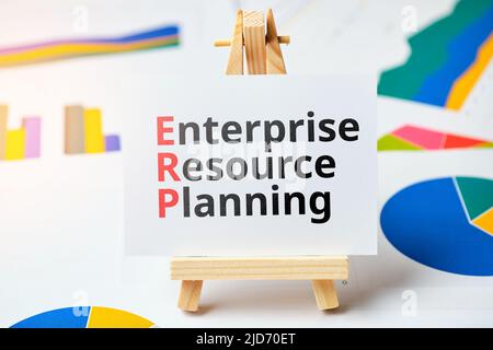Concept ERP or Enterprise Resource Planning. Business acronym. The inscription on the stand against the background of graphs Stock Photo