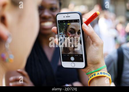 Turin, Italy. 18th June, 2022. An activist puts on makeup before the Torino Pride 2022. Credit: MLBARIONA/Alamy Live News Stock Photo