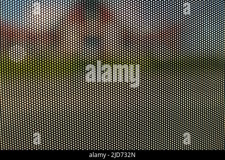 Mesh texture on glass. Shooting window. Small cage. Textured surface. Stock Photo